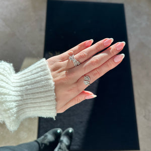 Female model wearing Diamond Bypass Leaf Ring -14k gold weighing 5.21 grams -64 round diamonds weighing .85 carats -40 straight baguettes weighing .88 carats