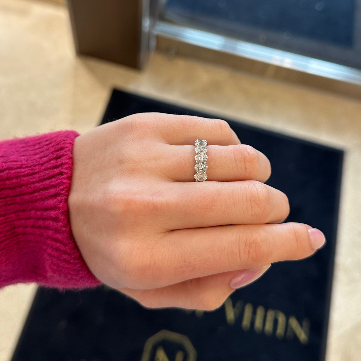 Female model wearing Diamond Ovals Wedding Band - Platinum white gold weighing 8.0 grams - F-color, VS2-SI1 clarity