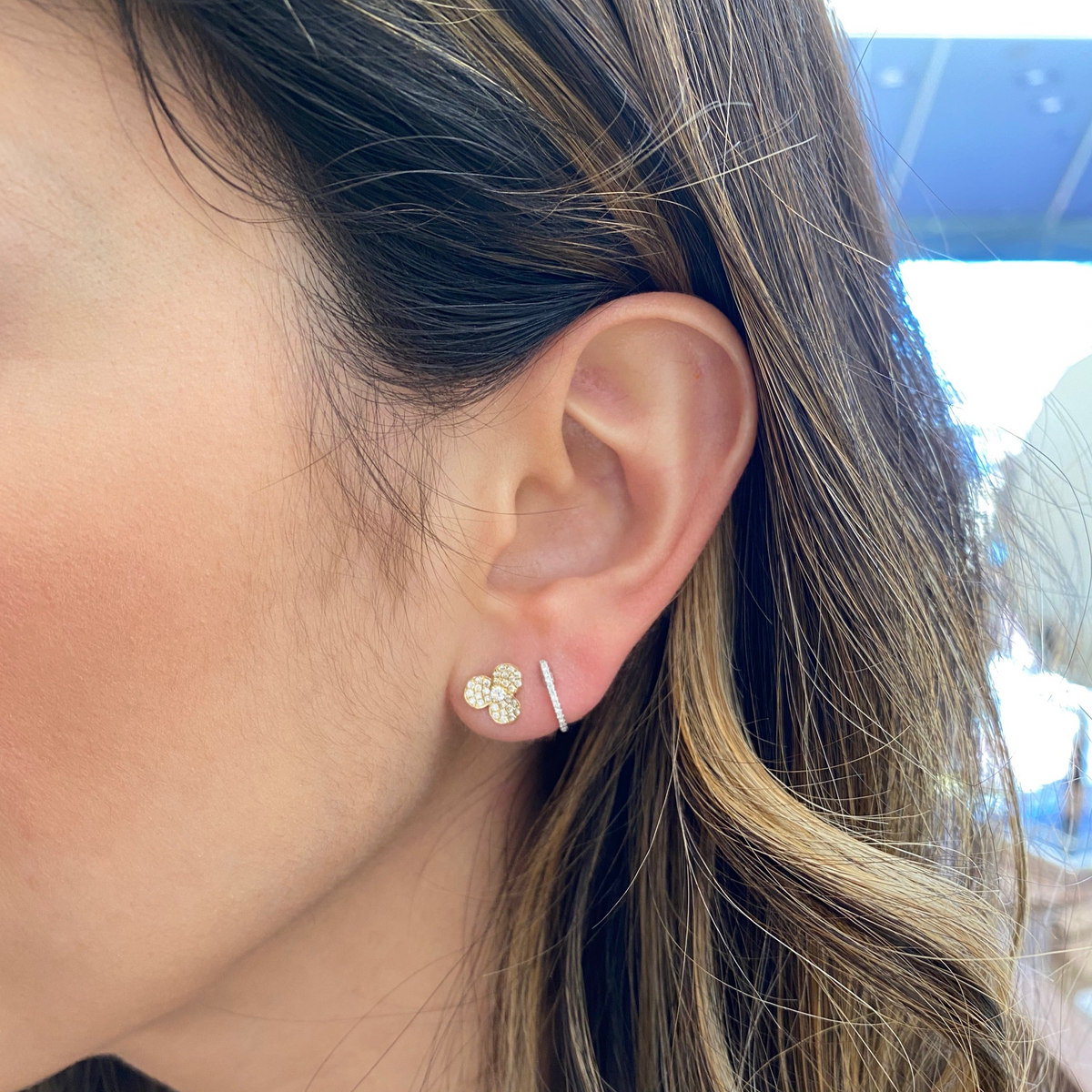 Female Model Wearing Diamond Pinwheel Stud Earrings - 14K gold weighing 1.41 grams - 62 round diamonds weighing 0.33 carats