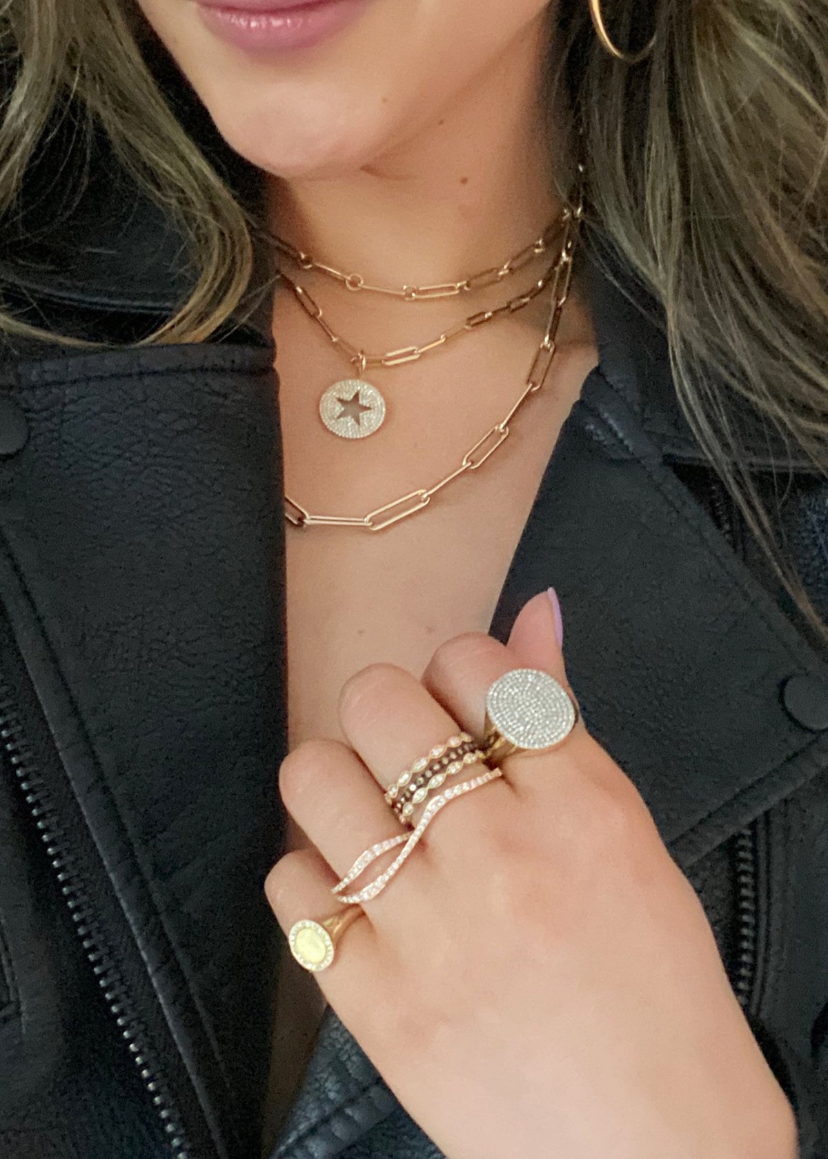 Female Model wearing Wavy Double-finger Diamond Ring  -18k gold 5.82 grams  -57 round shared prong-set diamonds .58 carats.