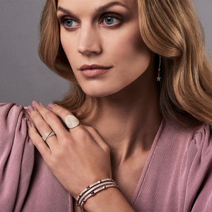 Female Model Wearing Diamond Dangling Star Earrings  -14K gold weighing 2.22 grams  -170 round pave-set diamonds totaling 0.55 carats.