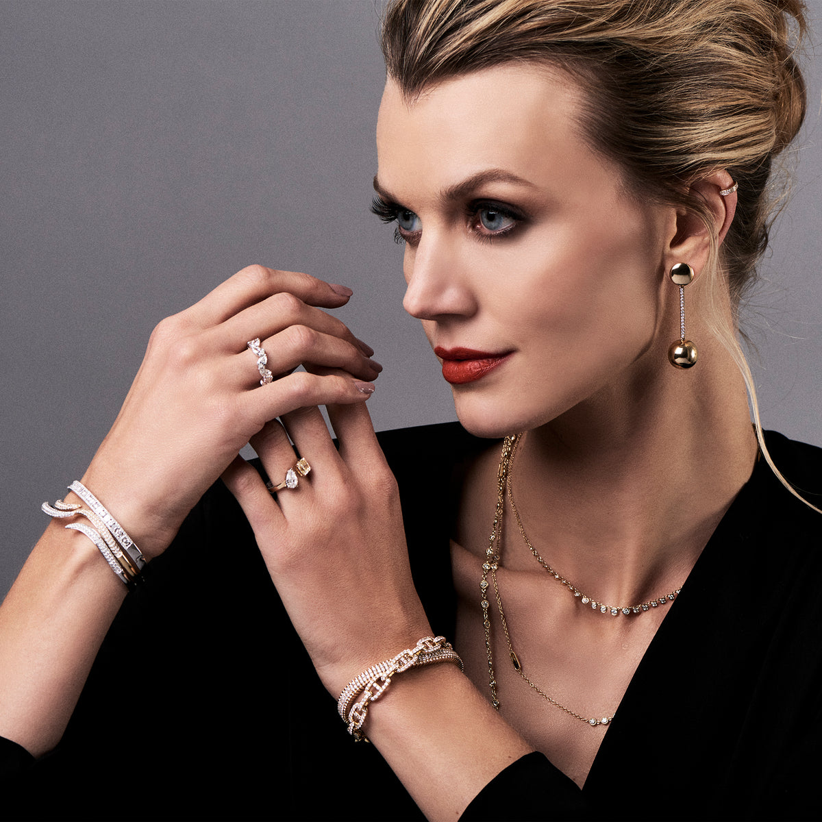 Female Model Wearing Gold Ball Drop Earrings with Diamonds  -14K gold weighing 12.50 grams  -0.30 tcw of round diamonds