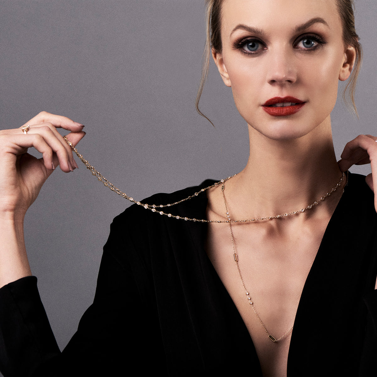Female model wearing Layered Diamond Station Necklace -18k gold 11.91 grams -24 round bezel-set diamonds 1.78 carats