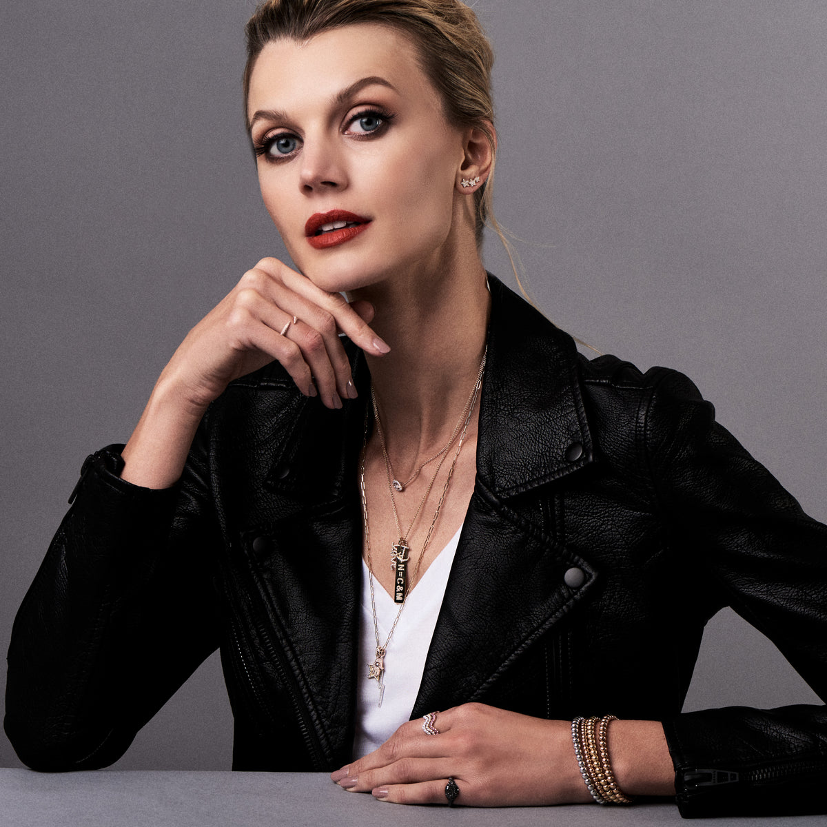 Female model wearing Diamond Anchor Pendant -19 round diamonds totaling 0.10 carats -14kt gold with a total weight of 0.5 grams