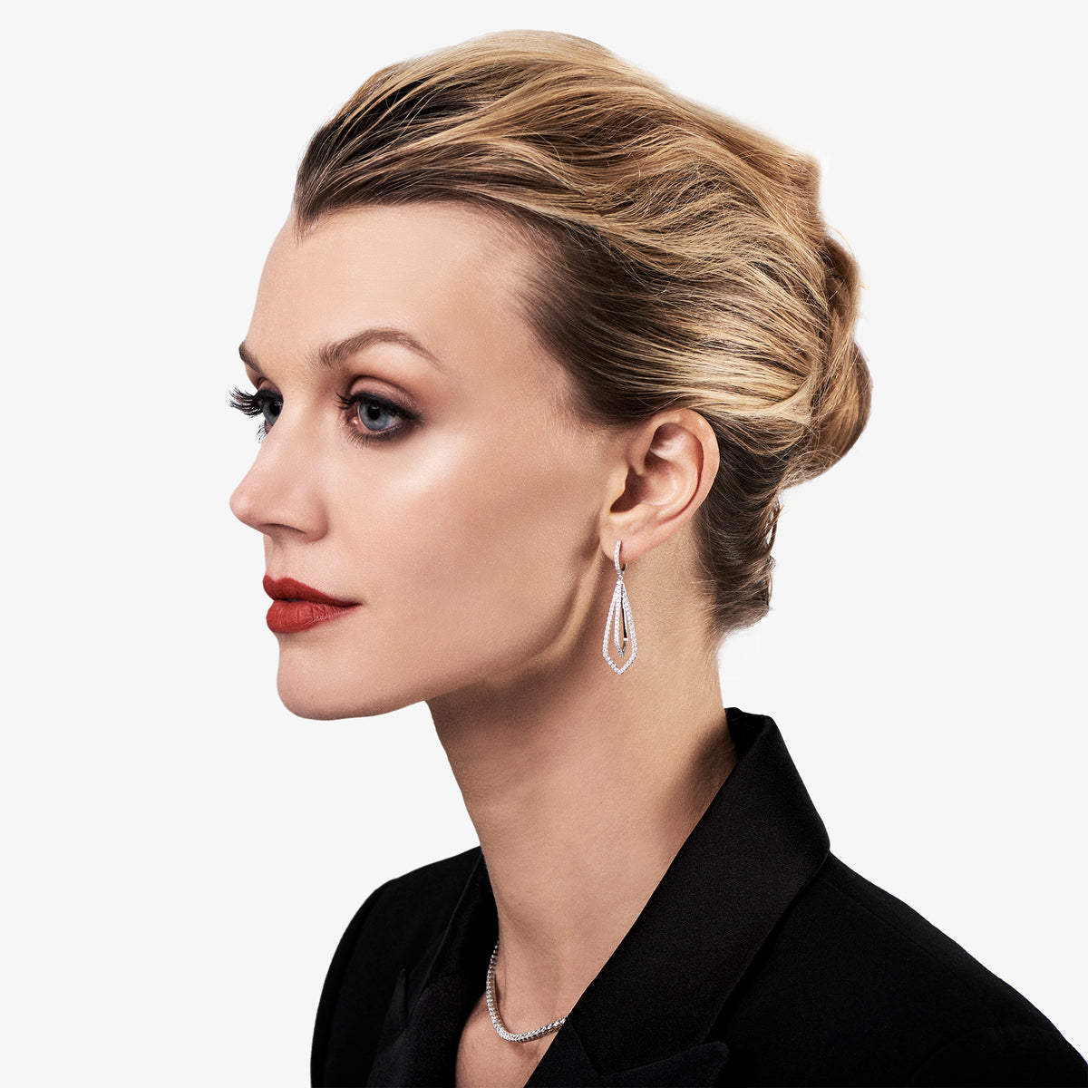 Female Model Wearing Diamond Geometric Drop Earrings  -18K gold weighing 5.9 grams  -128 round shared prong-set diamonds totaling 1.40 carats