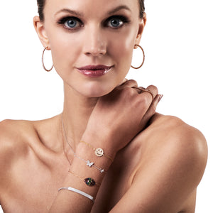 Female model wearing Diamond Smiley-Face Fashion Bracelet -14K gold weighing 2.06 grams -101 round diamonds totaling 0.24 carats