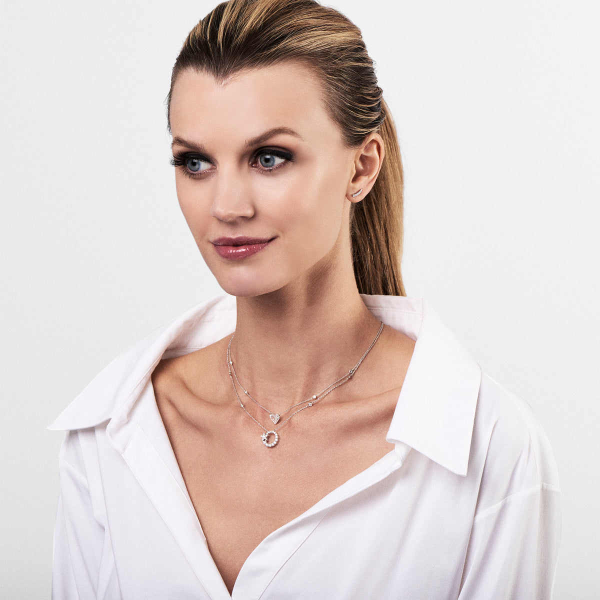 Female Model Wearing Diamond Circle Pendant Necklace with Star   - 18K gold weighing 4.67 grams.   - 32 round diamonds totaling 0.86 carats.