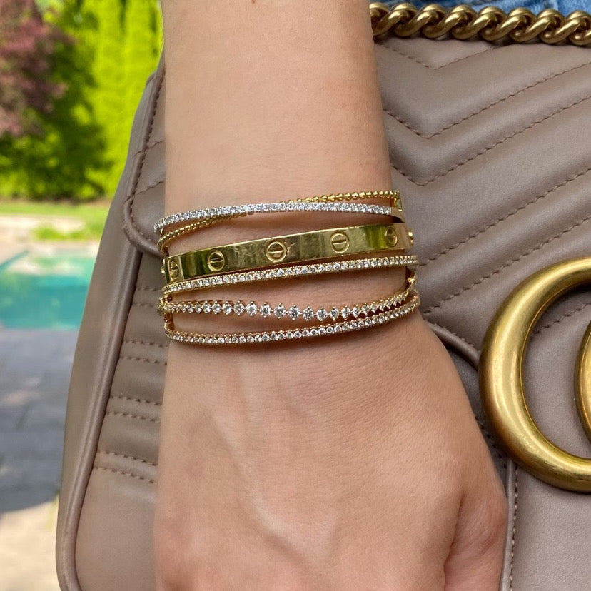 Prong-Set Diamond Wave Bangle  - 14K gold weighing 8.05 grams  - 27 round diamonds totaling 1.09 carats