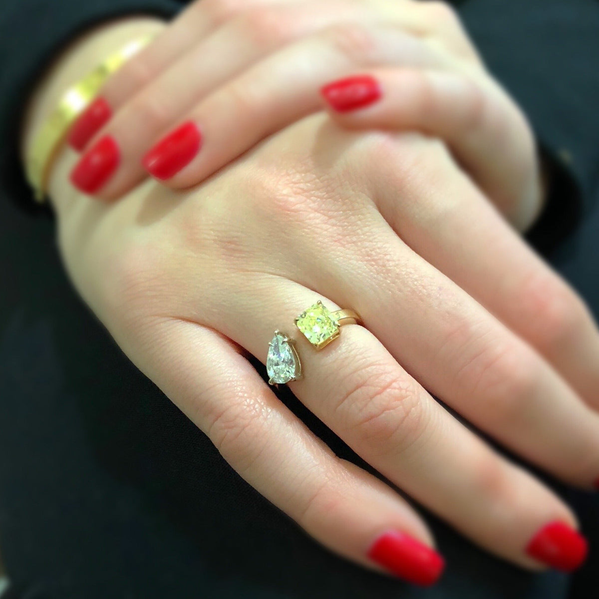 Unique Mixed Shape Two-stone Diamond Ring  -14k gold weighing 3.99 grams  -1 pear-shaped diamond weighing 1.25 carats  -1 fancy light yellow diamond radiant-cut weighing 1.25 carats with GIA-VS2 clarity