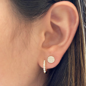 Female model wearing Diamond Disc Stud Earrings -14k gold weighing 1.38 grams -76 round pave-set diamonds totaling 0.22 carats. Approx. diameter is 6.85mm