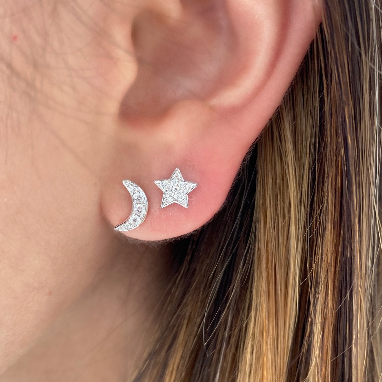 Diamond Moon & Star Stud Earrings - 14K white gold weighing 1.14 grams. - 19 round diamonds totaling 0.13 carats.