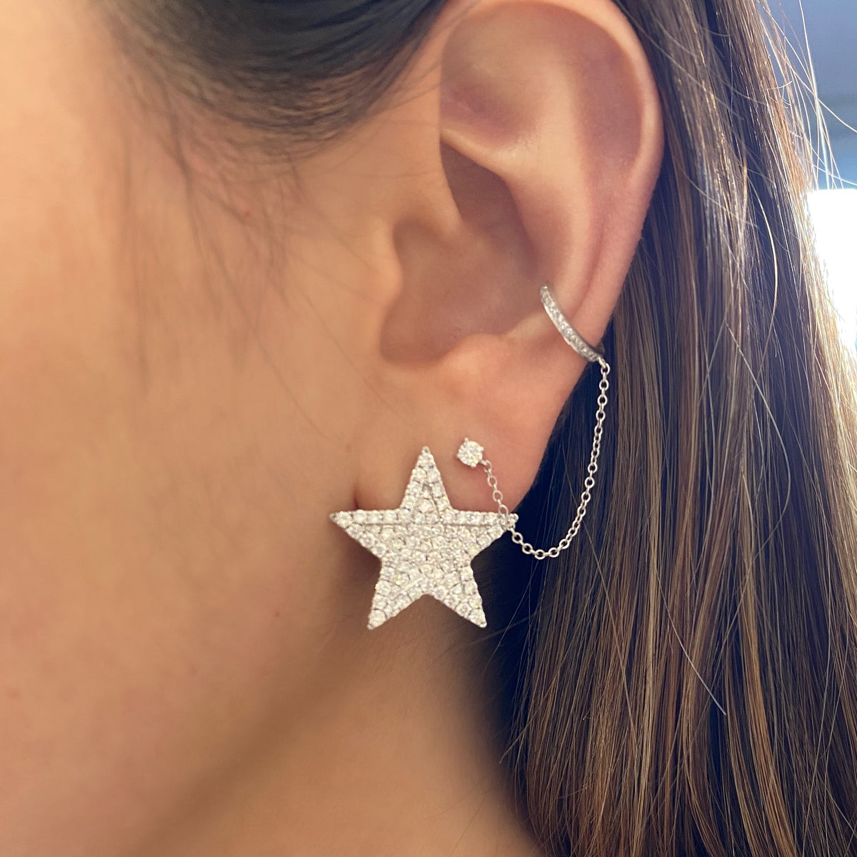 Female model wearing Diamond Ear Cuff with Chain and Diamond Stud - 14K gold weighing 1.05 grams - 15 round diamonds totaling 0.11 carats