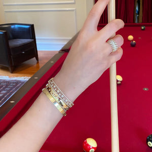 Female Model Wearing Diamond Star Bangle  - 14K gold weighing 16.16 grams  - 35 round diamonds totaling 0.29 carats