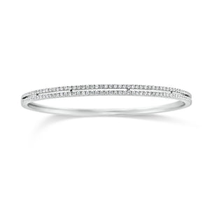 Diamond Double Row Bangle Bracelet - 18K white gold weighting 11.70 grams. - 118 Round Diamonds totaling 0.96 carats.