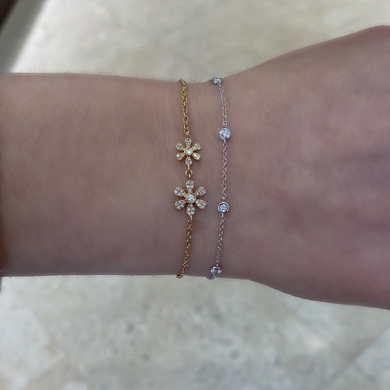 Diamond Adjustable Flower Bracelet -14K yellow gold weighing 2.31 grams -52 round diamonds totaling 0.19 carats -Adjustable bead closure