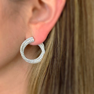 Female Model Wearing Diamond Front-Facing Twist Hoop Earrings     -14K gold weighing 9.71 grams  -214 round pave-set diamonds totaling 3.55 carats