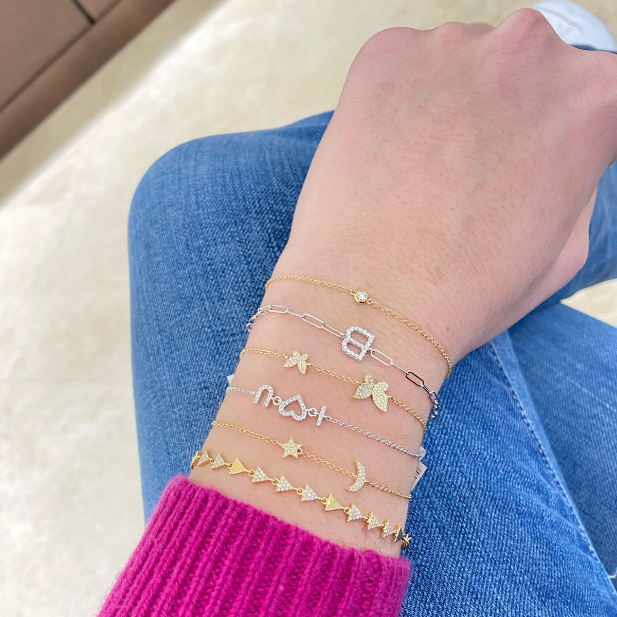 Female model wearing Diamond “I <3 You” Bracelet - 14K gold weighing 1.23 grams - 33 round diamonds totaling 0.08 carats