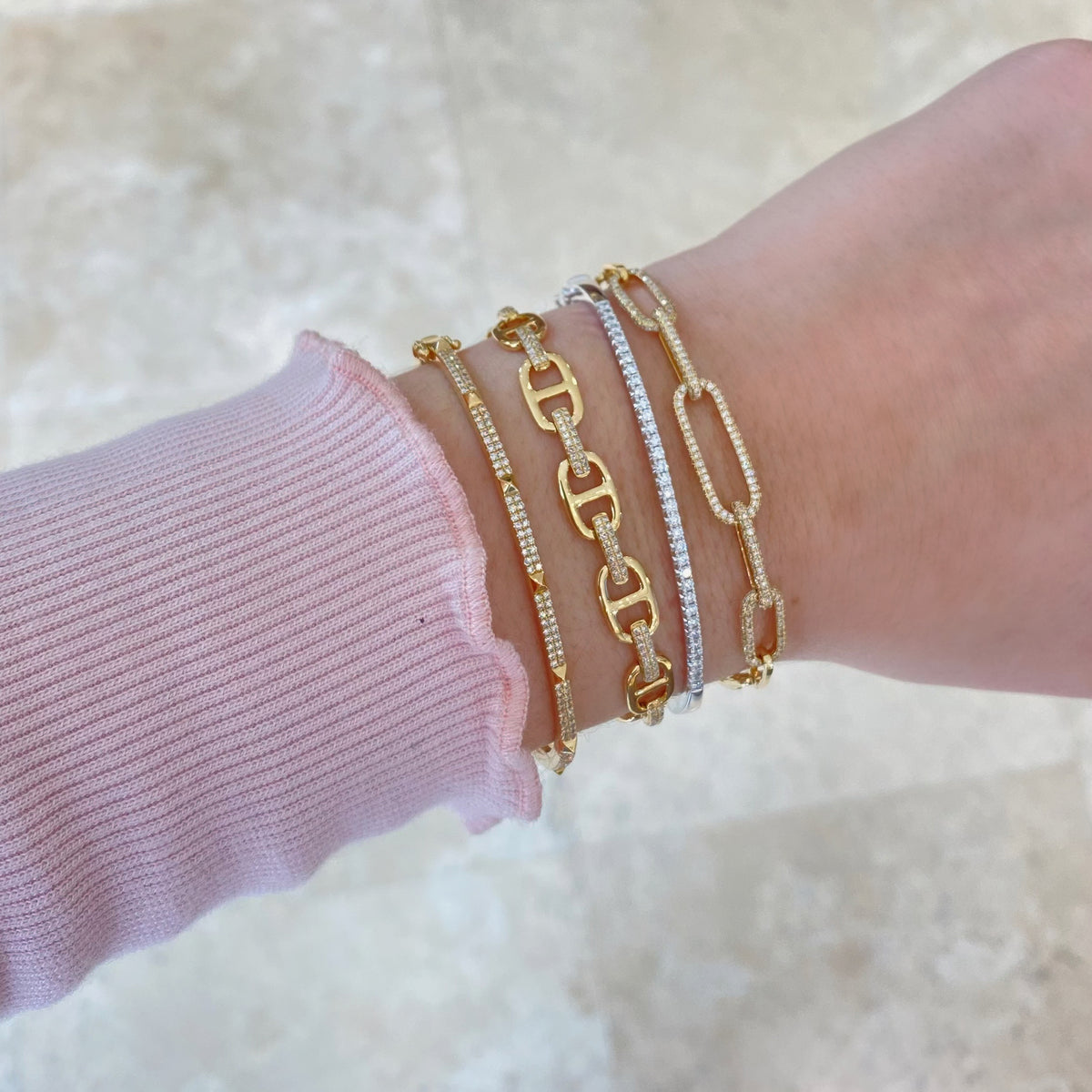 Female model wearing Diamond Paperclip Chain Bracelet - 14K gold weighing 8.00 grams - 374 round diamonds totaling 1.20 carats