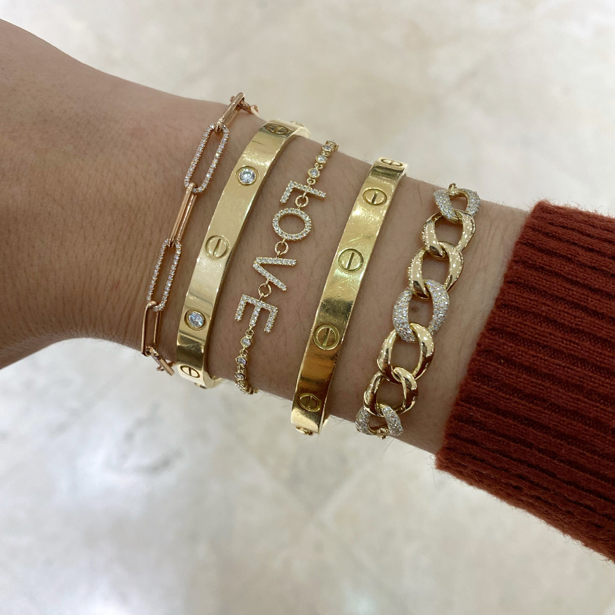 Female model wearing Diamond Paperclip Chain Bracelet - 14K gold weighing 5.42 grams - 420 round diamonds totaling 1.18 carats