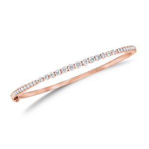 Graduated Diamond Bangle Bracelet - 18K rose gold weighing 10.79 grams - 22 round diamonds totaling 0.39 carats - 13 round diamonds totaling 0.91 carats