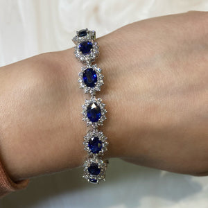 Female Model Wearing Sapphire & Diamond Wreath Bracelet  - 18K gold weighing 20.37 grams  - 180 round diamonds totaling 5.29 carats  - 15 sapphires totaling 13.14 carat