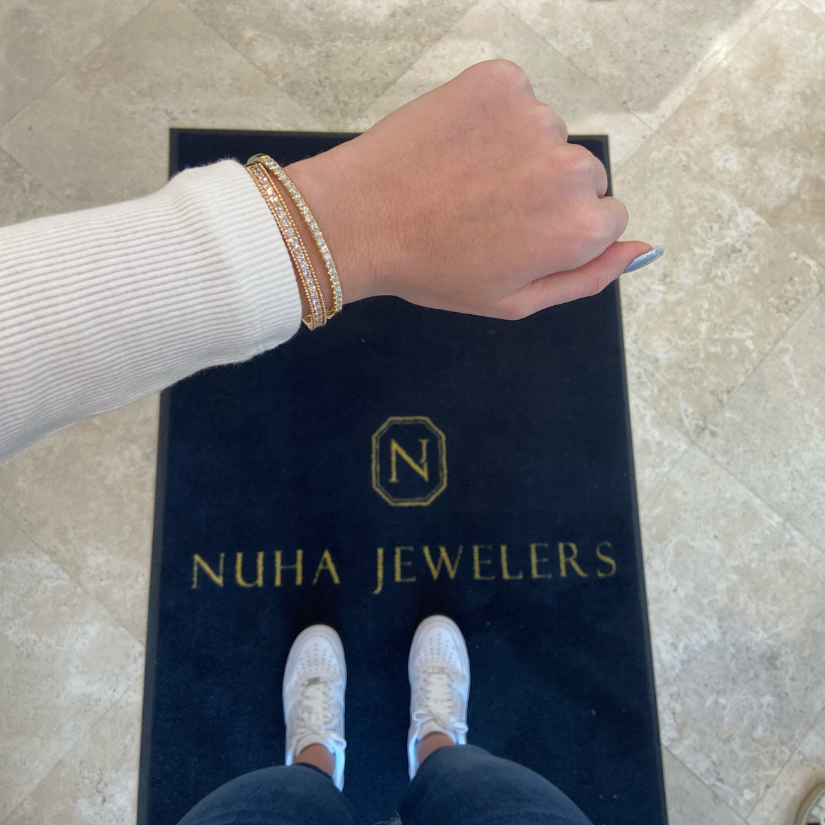 Female model wearing Diamond Beaded Gold Bangle -18K gold weighing 19.28 grams -25 round diamonds totaling 2.25 carats