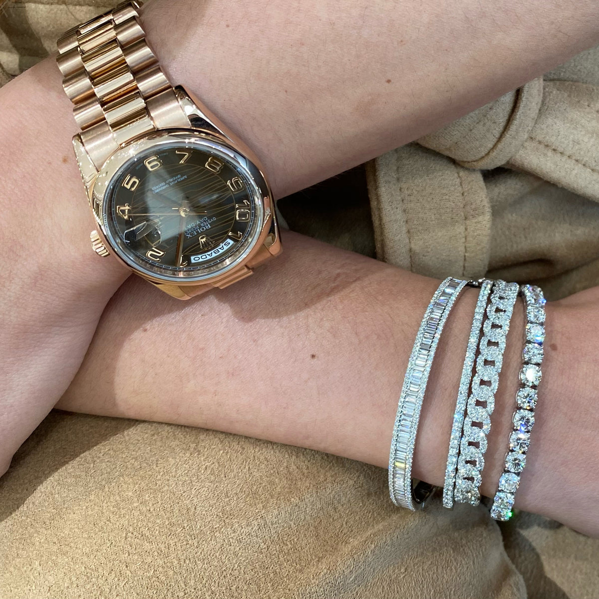 Female model wearing Baguette & Round Diamond Bangle Bracelet - 18K white gold weighing 17.15 grams - 126 round diamonds totaling 0.56 carats - 58 slim baguettes totaling 1.78 carats