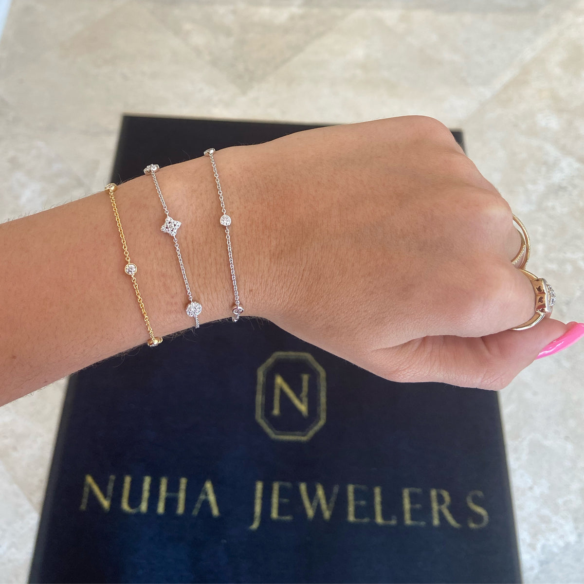 Female model wearing Diamonds by the Yard 5-Stone Bracelet - 18K gold weighing 2.75 grams - 5 round diamonds totaling 0.49 carats