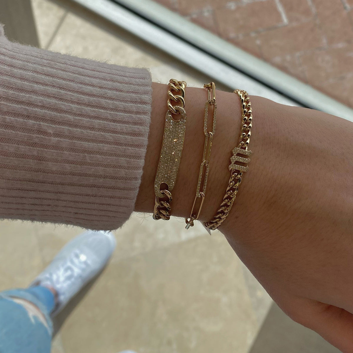 Female model wearing Diamond Paperclip Chain Bracelet - 14K gold weighing 5.42 grams - 420 round diamonds totaling 1.18 carats