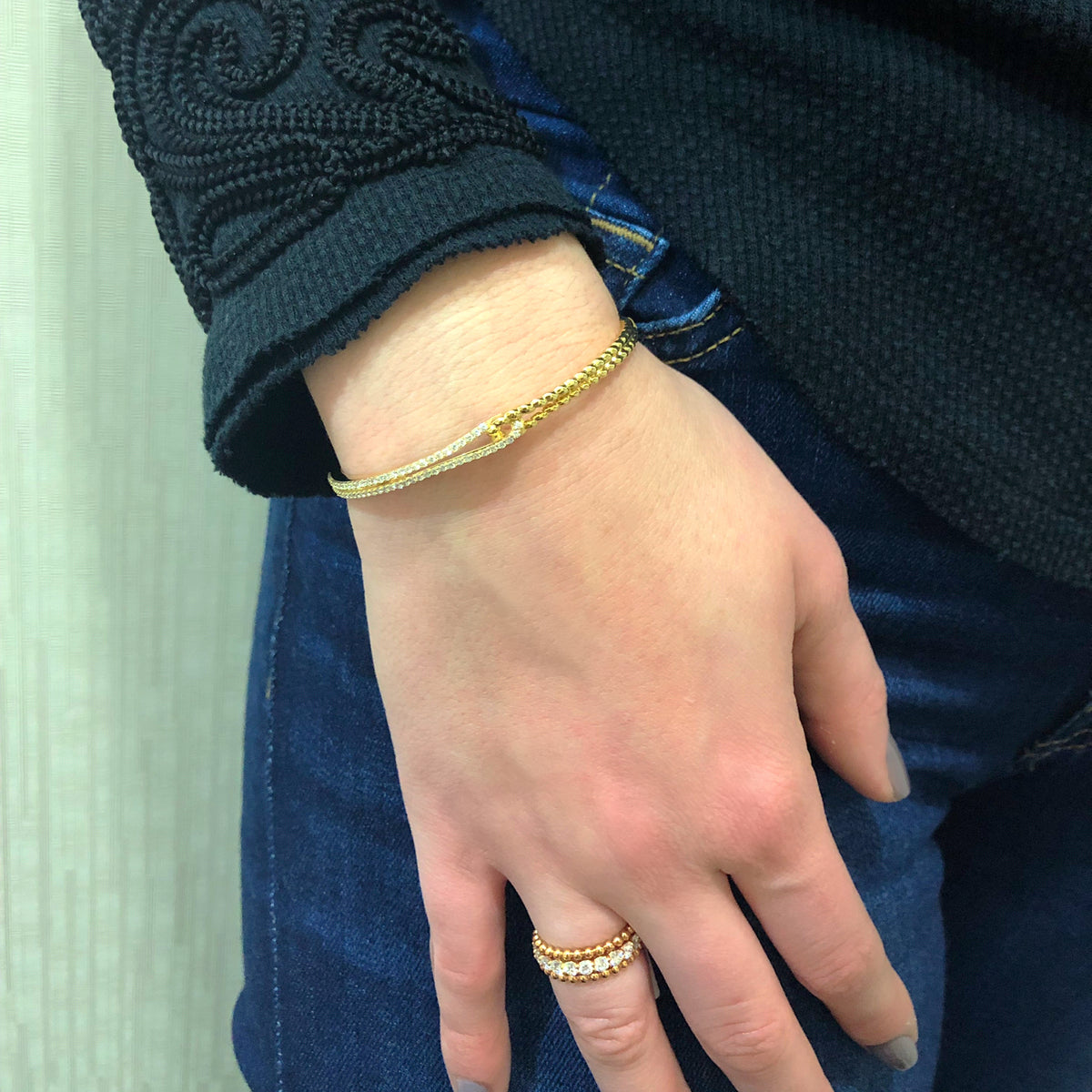 Female Model Wearing Diamond Linked Rope Bangle Bracelet  -18K gold weighing 13.09 grams  -66 round diamonds totaling 0.73 carats