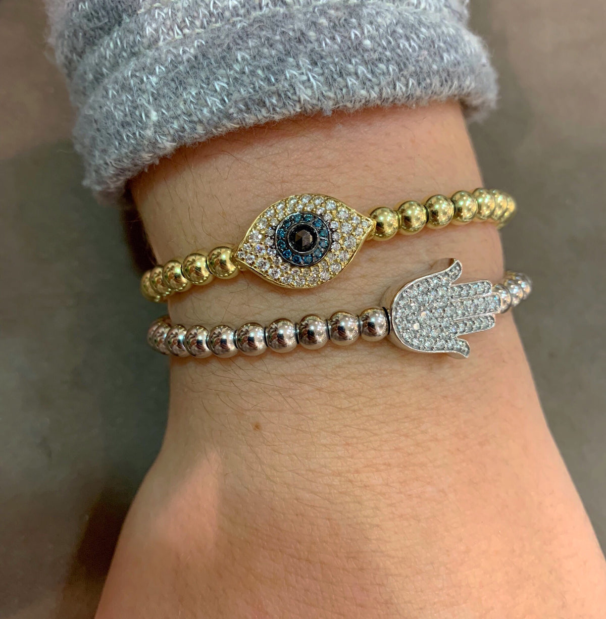 Female model wearing Diamond Hamsa Stretch Bracelet - 14K gold weighing 14.30 grams - 44 round diamonds totaling 0.53 carats