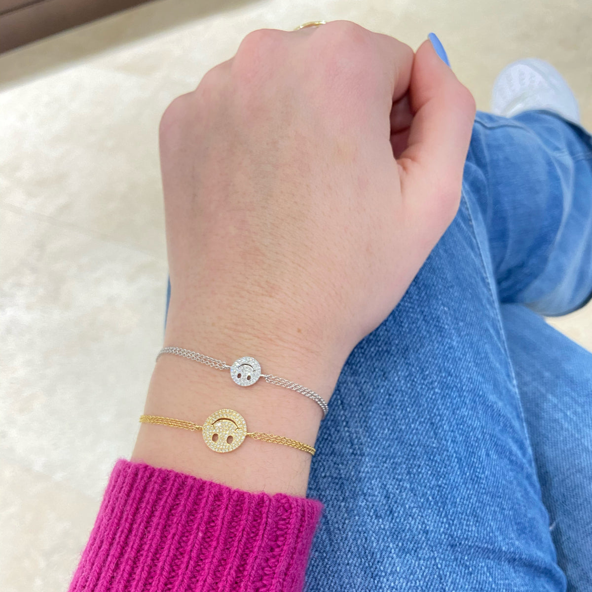 Female model wearing Diamond Smiley-Face Fashion Bracelet -14K gold weighing 2.06 grams -101 round diamonds totaling 0.24 carats