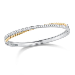 Diamond Two-Tone Crossover Bangle Bracelet  -14K gold weighing 15.82 grams  -39 round channel-set diamonds totaling .80 carats