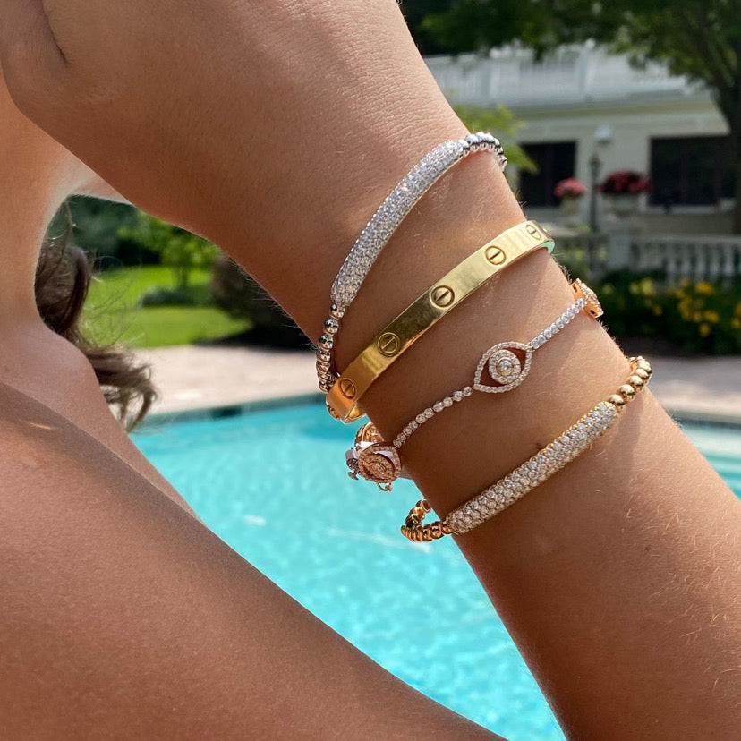 Diamond Bracelet with Evil Eye Stations  - 18K gold weighing 8.14 grams  - 236 round diamonds totaling 2.67 carats