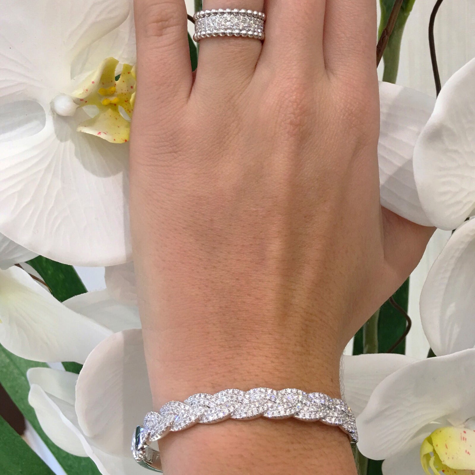 Diamond Braided Bangle Bracelet  -18K gold weighing 26.13 grams  -212 round pave-set diamonds totaling 2.05 carats.