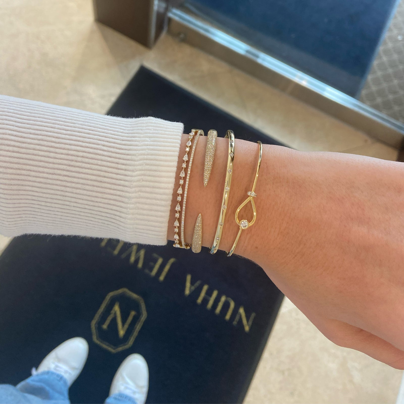 Diamond simple bangle bracelet -14K gold weighing 10.13 grams  -9 round diamonds totaling 0.26 carats.  - 3mm wide.