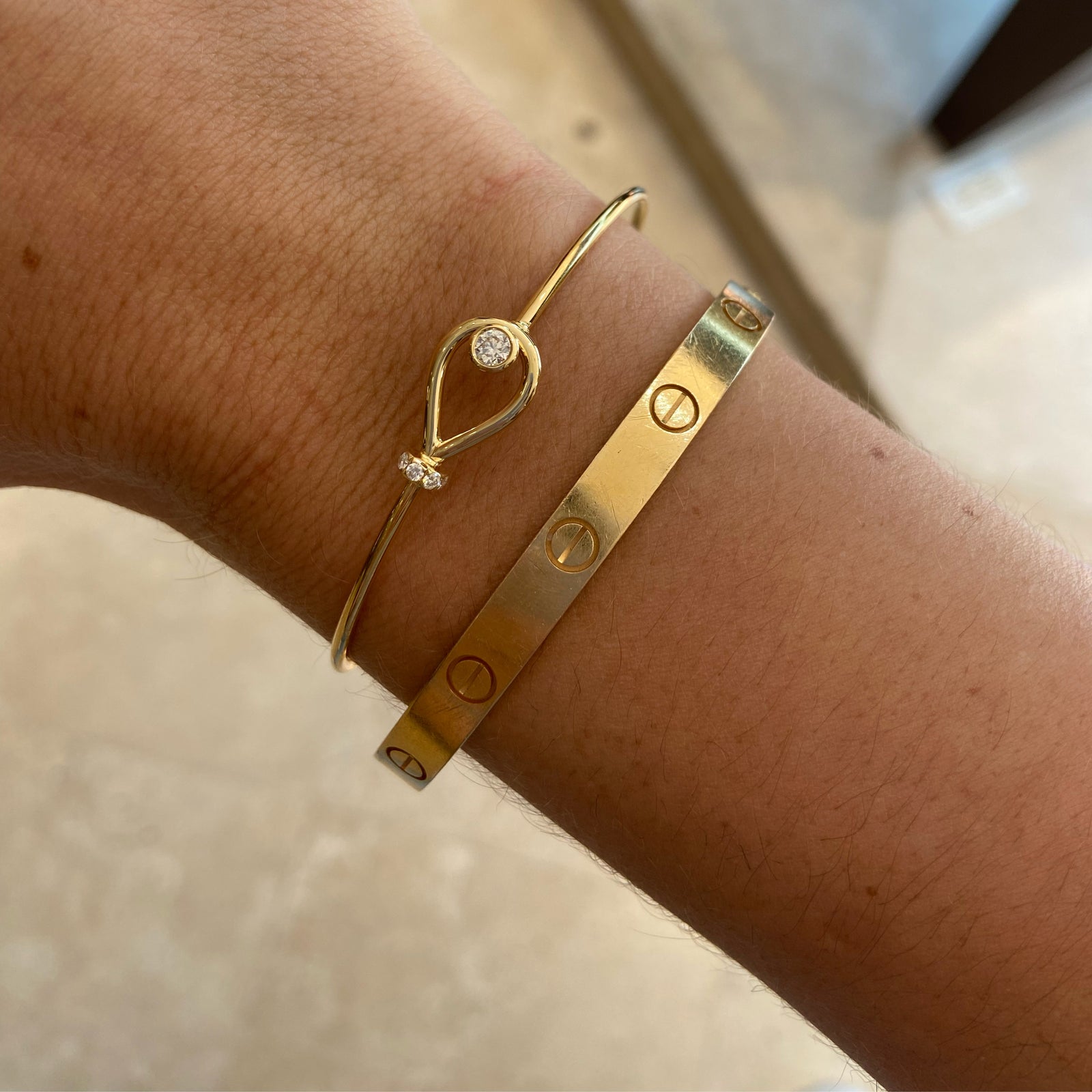 Diamond Loop Bangle Bracelet  - 18K gold weighing 4.43 grams  - 6 round diamonds totaling 0.22 carats