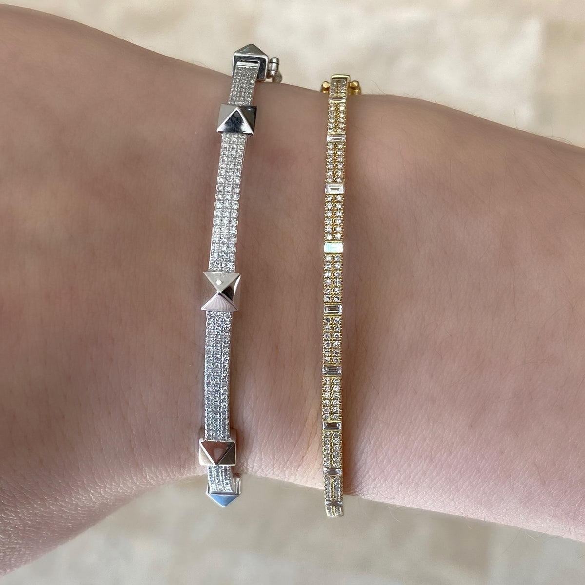 Female Model Wearing Round & Baguette Diamond Bangle Bracelet  -14K gold weighing 9.14 grams  -9 baguettes totaling 0.26 carats  -120 round diamonds 0.33 carats