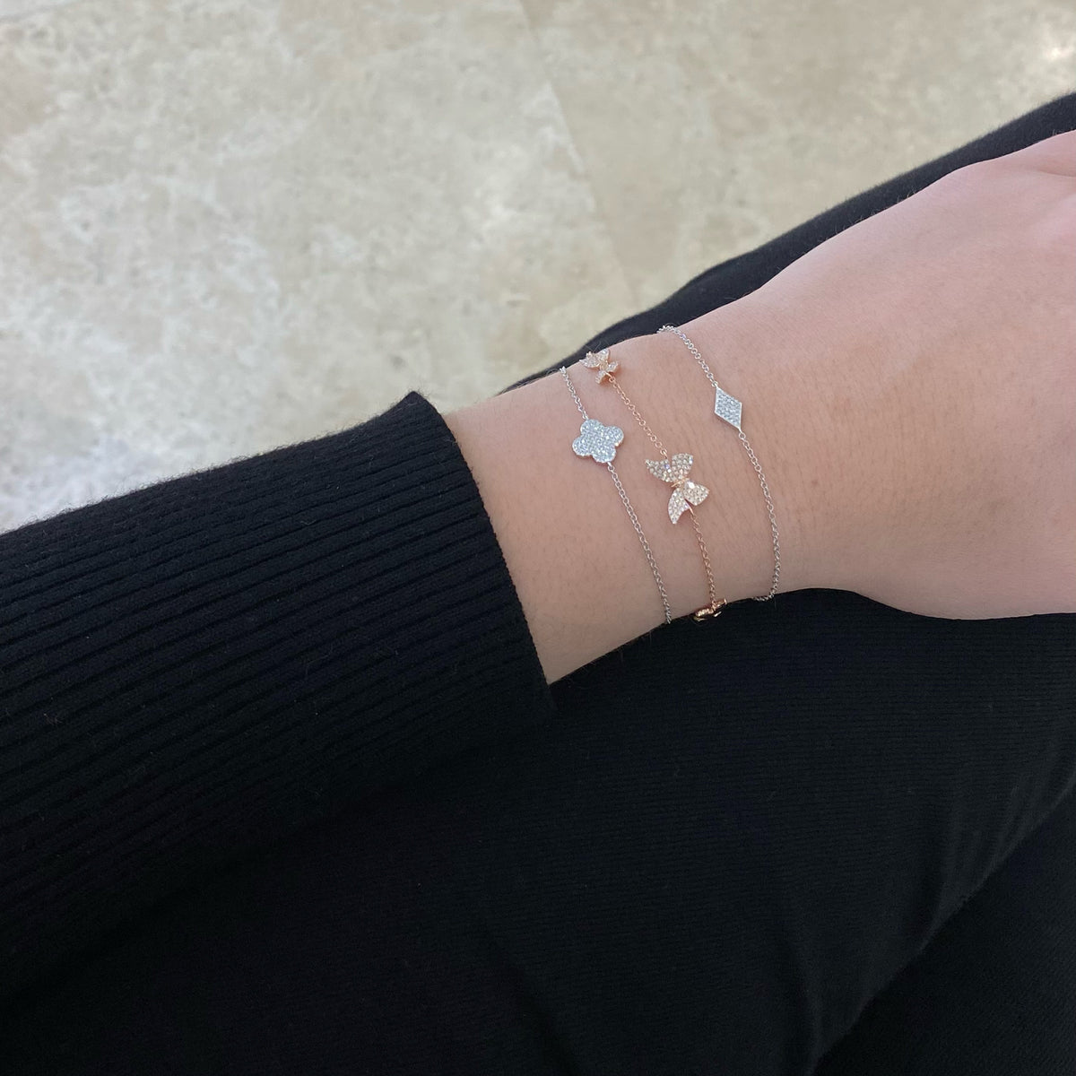 Female model wearing Diamond Shape Fashion Bracelet - 14K gold weighing 1.10 grams - 0.06 cts round diamonds