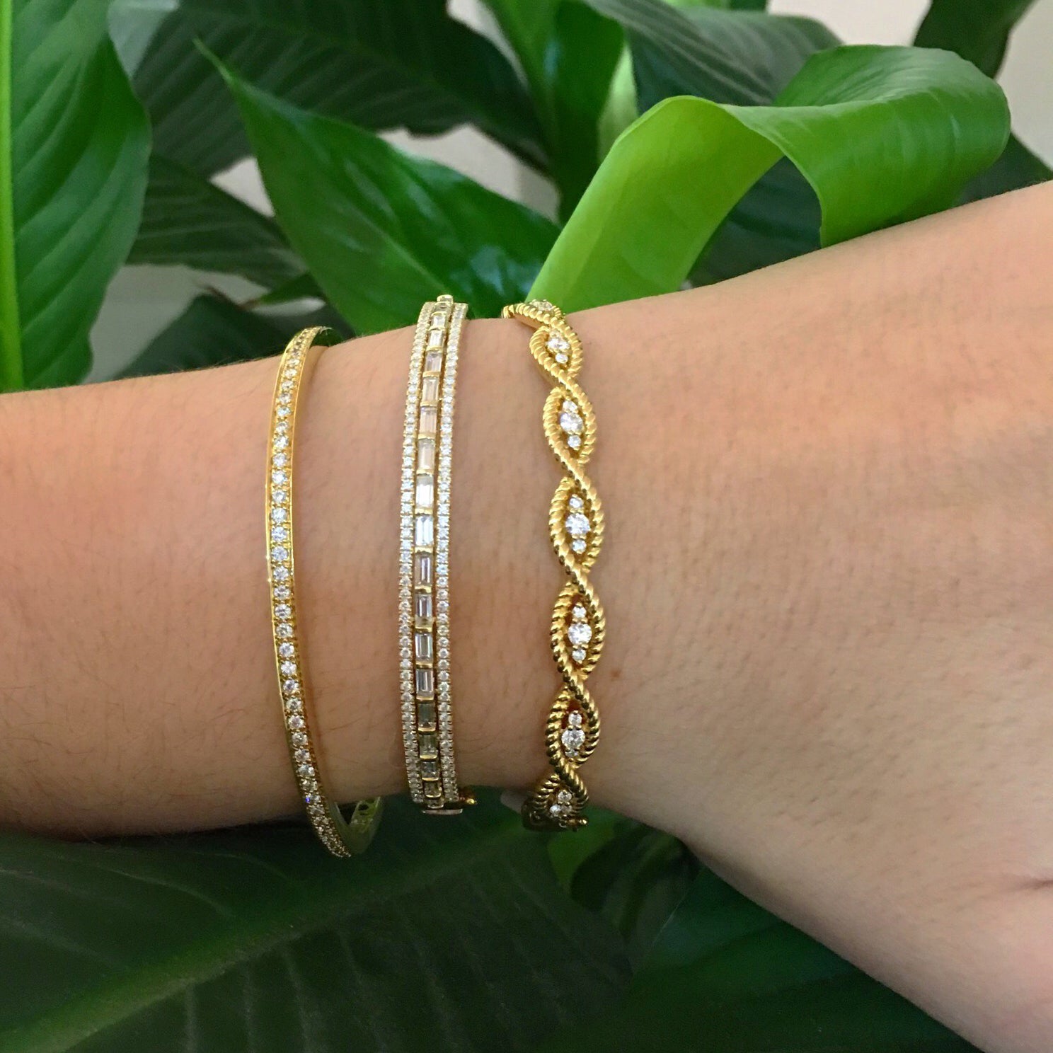 Diamond Baguette Bangle Bracelet  -18K gold weighing 21.17 grams  -114 round diamonds weighing .65 carats  -19 straight baguettes weighing 1.42 carats