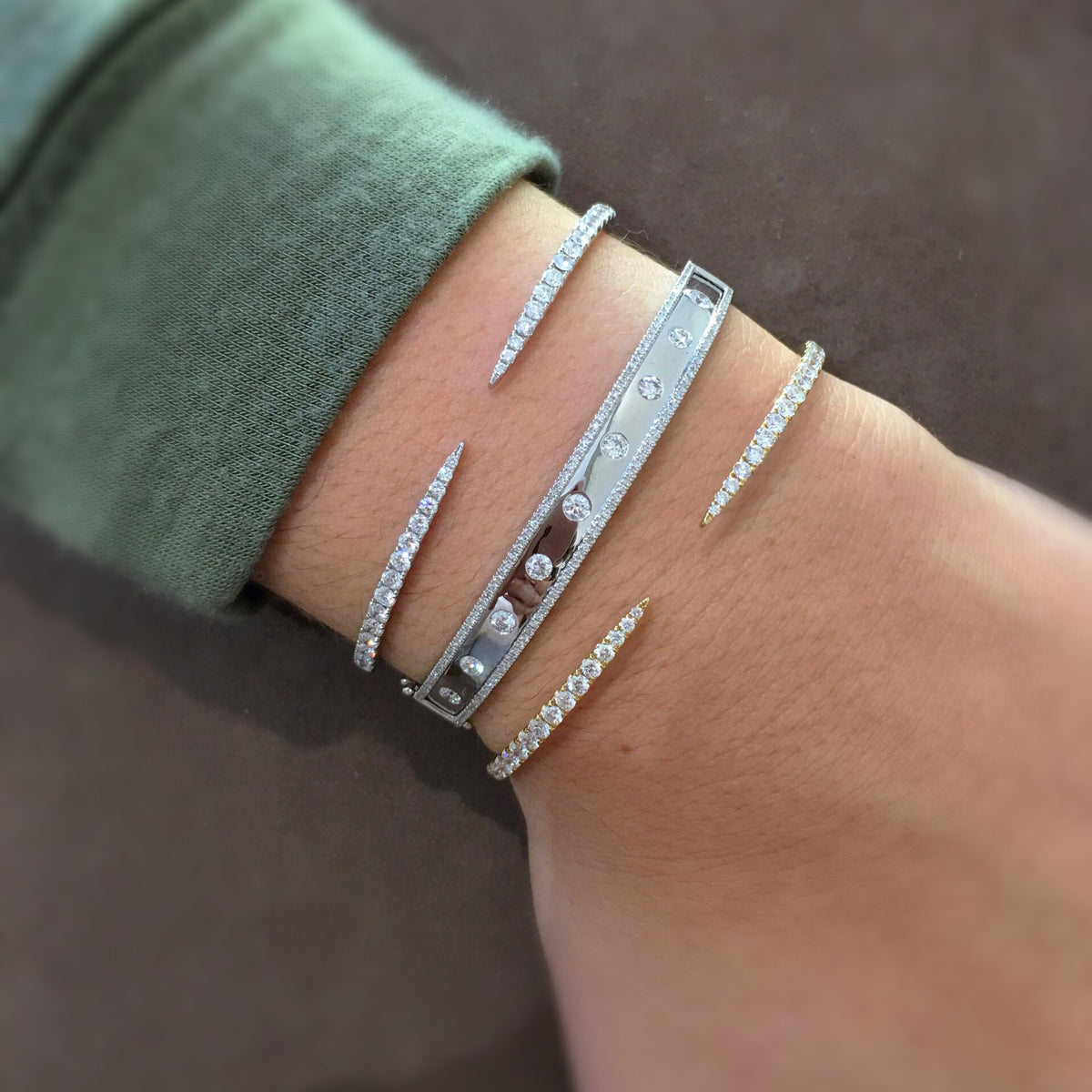 Female model wearing Bezel-Set & Pave Diamond Wide Bangle Bracelet -14K gold weighing 14.45 grams -9 round bezel set diamonds totaling 0.52 carats -146 round pave set diamonds totaling 0.44 carats