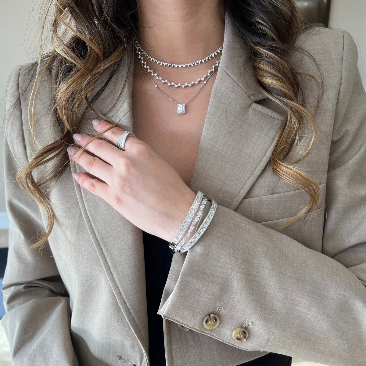 Female model wearing Round & Baguette Diamond Bangle - 14K gold weighing 13.12 grams - 143 round diamonds totaling 1.92 carats - 24 straight baguettes weighing 0.73 carats