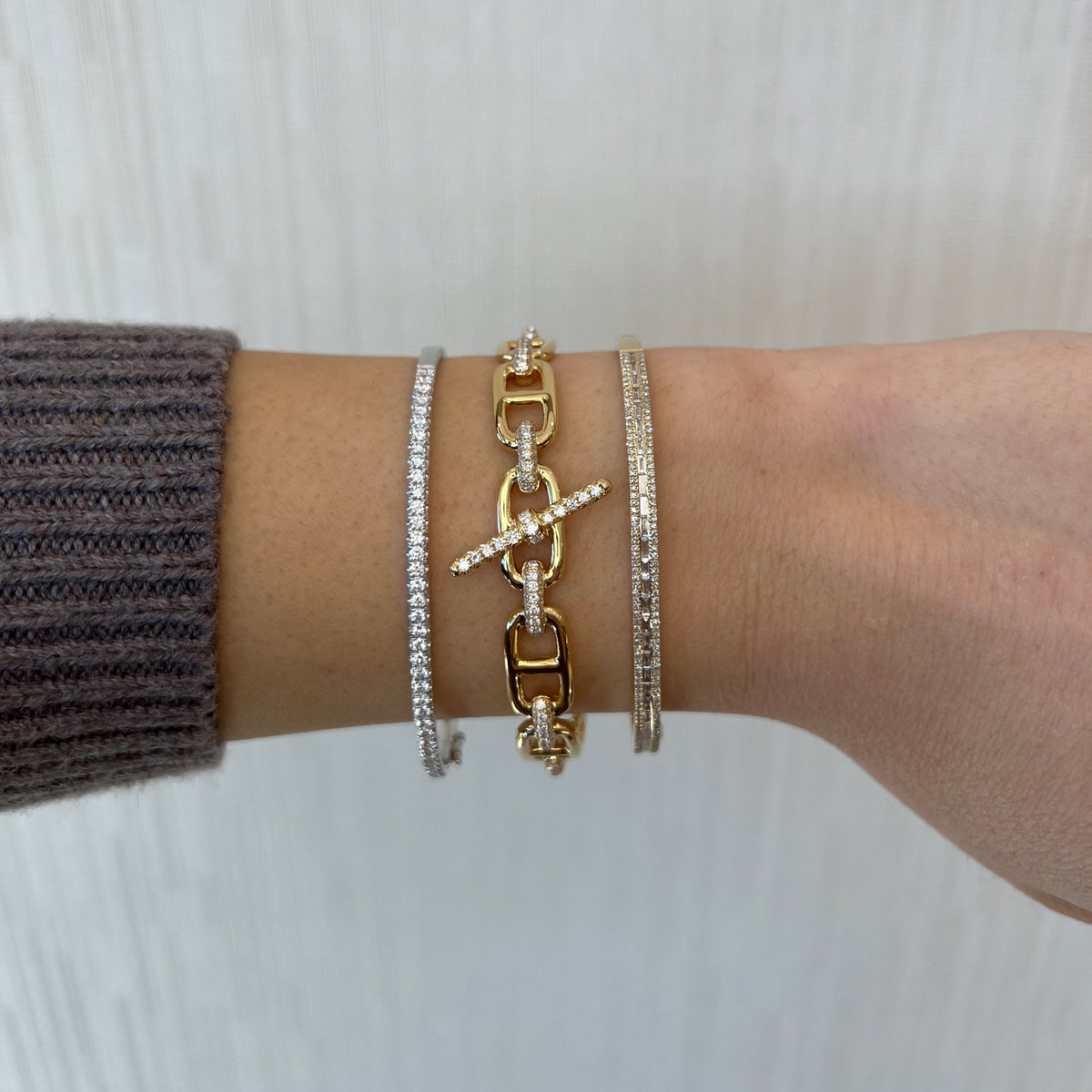 Female Model Wearing Pave Diamond Toggle Chain Link Bangle Bracelet -18K gold weighing 25.05 grams  -147 round diamonds weighing 1.35 carats