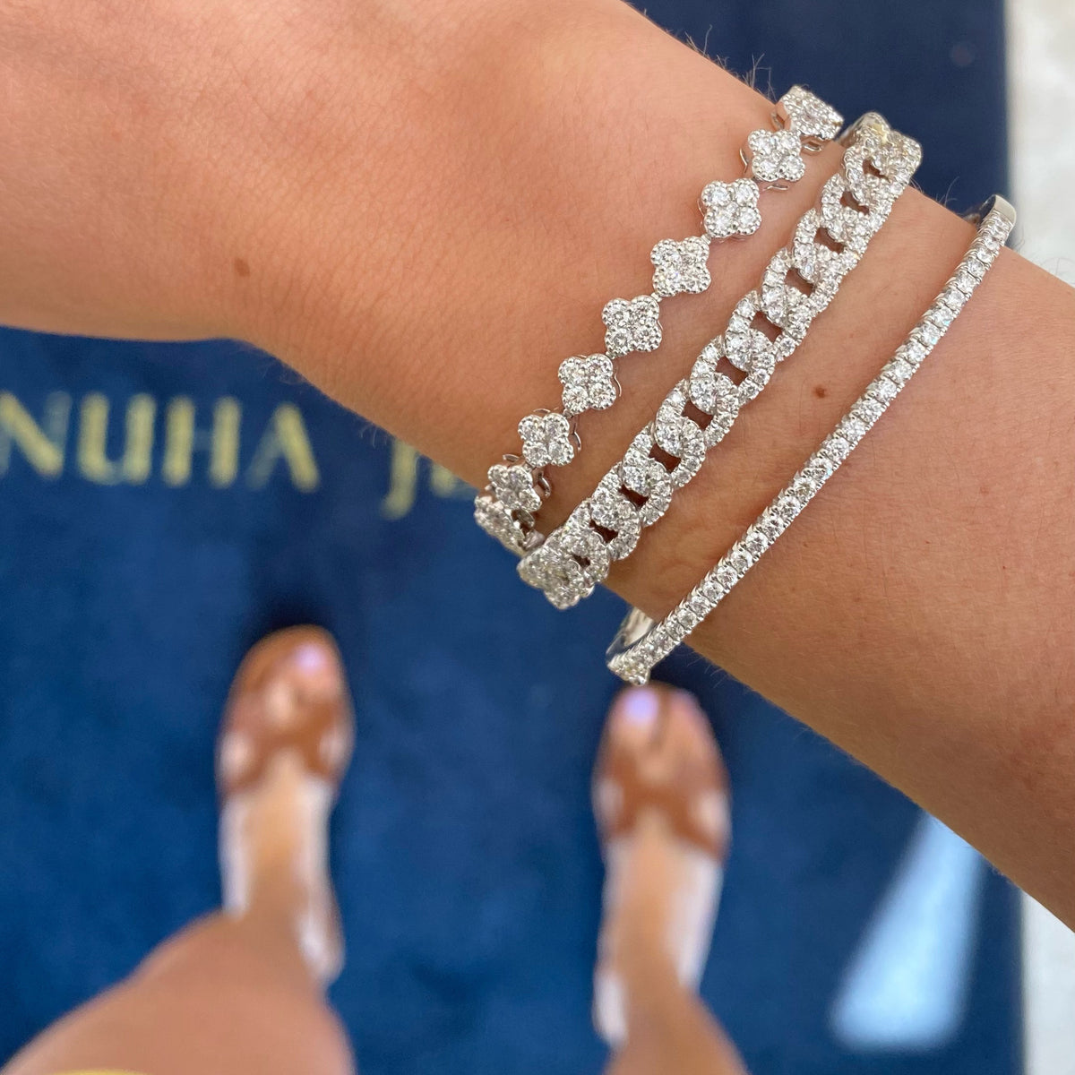 Female Model Wearing Diamond Quatrefoil Bracelet  - 18K gold weighing 12.76 grams  - 145 round diamonds totaling 3.79 carats