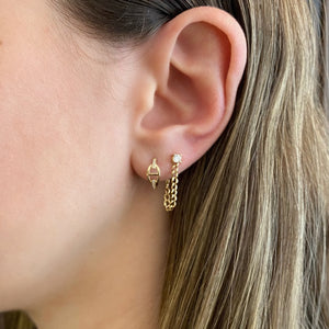 Female Model Wearing Diamond Tri-Link Huggie Earrings - 14K gold weighing 1.40 grams  - 20 round diamonds totaling 0.06 carats