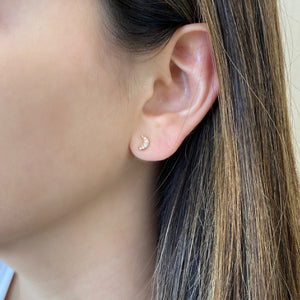 Female model wearing Diamond Moon & Star Crawler Earrings - 14K gold weighing 1.37 grams - 8 round diamonds totaling 0.09 carats