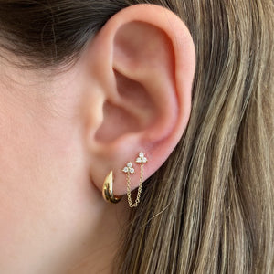 Female model wearing Gold bold huggie earrings - 14K gold weighing 3.08 grams