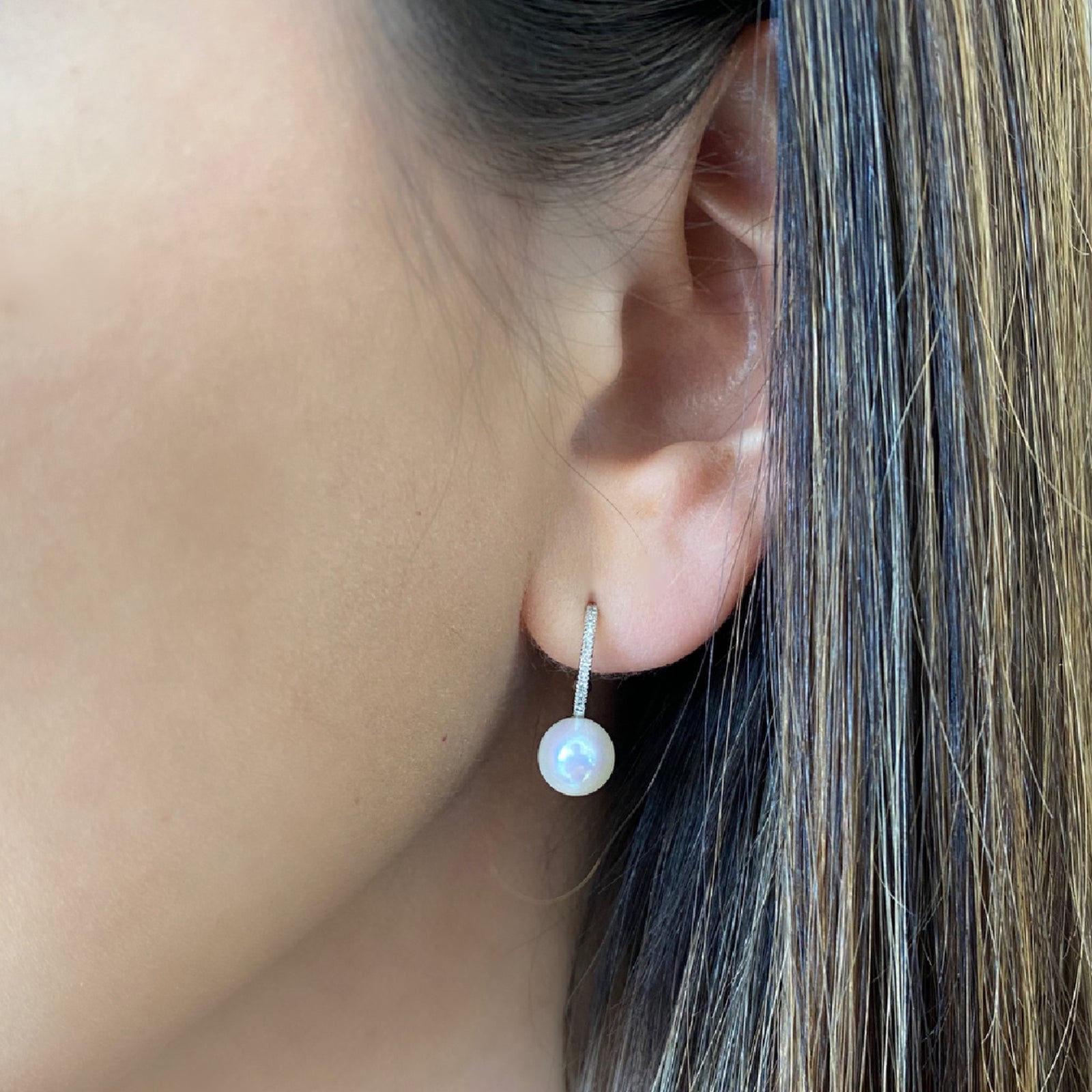 Pearl and Diamond Open Huggie Earrings  - 14 kt gold weighing 1.38 grams  - 30 round diamonds weighing 0.07 carats  - 2 pearls