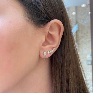 Female model wearing Diamond Halo Climber Earrings - 14K gold weighing 1.37 grams - 82 round diamonds totaling 0.29 carats