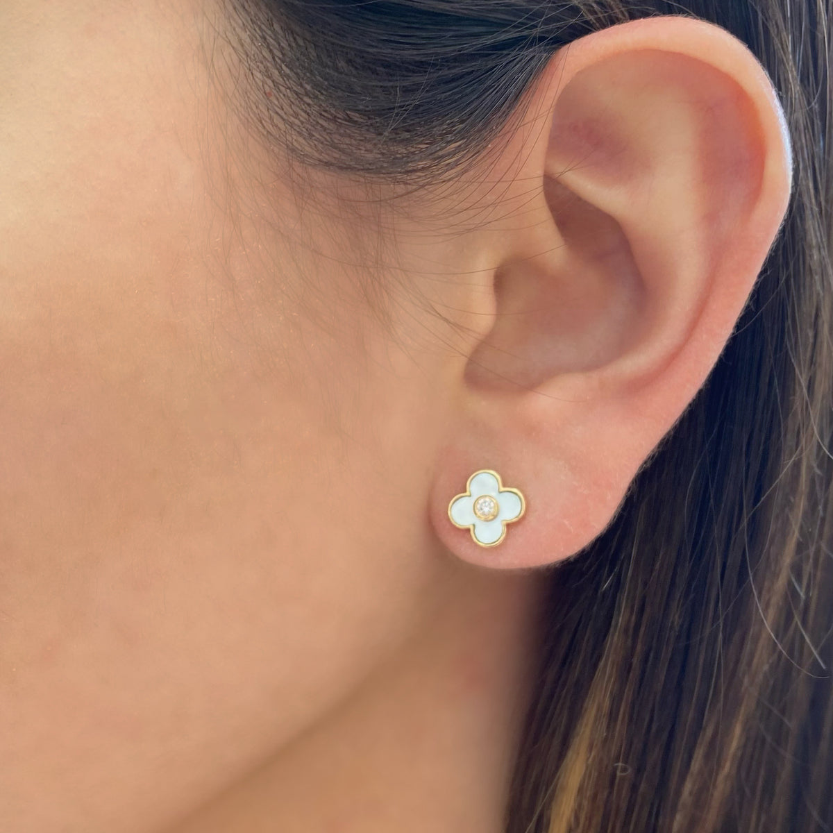 Female model wearing Turquoise Diamond Clover Stud Earrings - 14K gold weighing 1.58 grams - 2 round diamonds totaling 0.08 carats